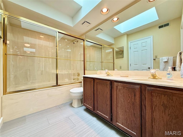 4235 W Pine Blvd Unit 21, Saint Louis, MO 63108 - full bath with a skylight, toilet, combined bath / shower with glass door, double vanity, and recessed lighting