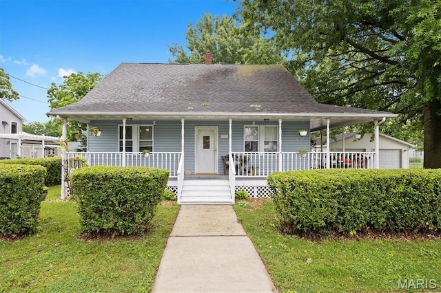 203 N Williams St, Albers, IL 62215 - view of front facade featuring covered porch, a front yard, a shingled roof, a chimney, and a garage