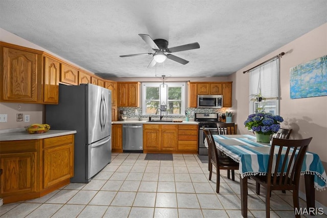 203 N Williams St, Albers, IL 62215 - kitchen featuring stainless steel appliances, brown cabinets, light countertops, a ceiling fan, and a textured ceiling