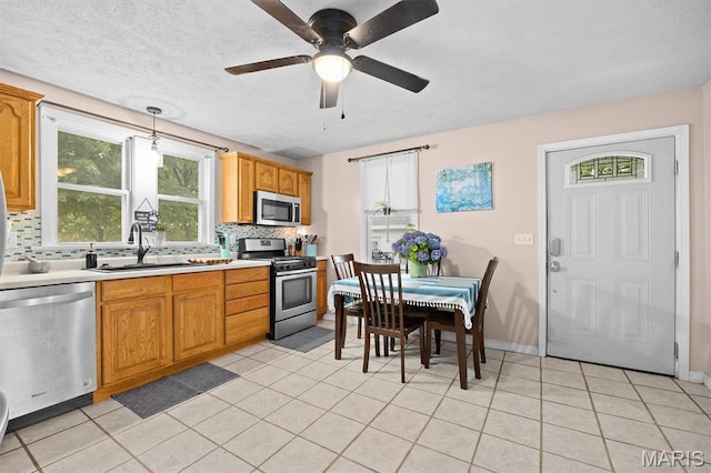 203 N Williams St, Albers, IL 62215 - kitchen with appliances with stainless steel finishes, a sink, decorative backsplash, light tile patterned flooring, and light countertops