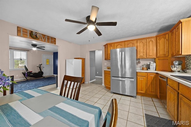203 N Williams St, Albers, IL 62215 - kitchen featuring stainless steel appliances, ceiling fan, light countertops, brown cabinets, and light tile patterned flooring