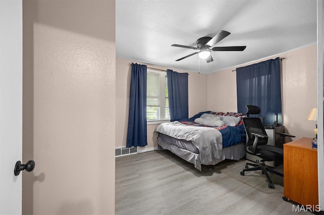 203 N Williams St, Albers, IL 62215 - bedroom featuring wood finished floors, a textured wall, ceiling fan, and a textured ceiling