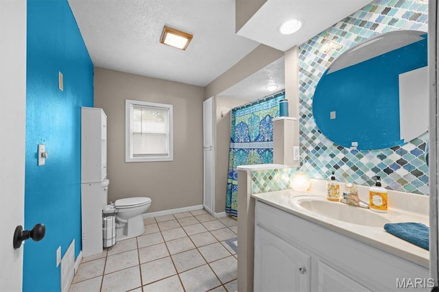203 N Williams St, Albers, IL 62215 - bathroom featuring baseboards, a textured ceiling, toilet, vanity, and tile patterned floors