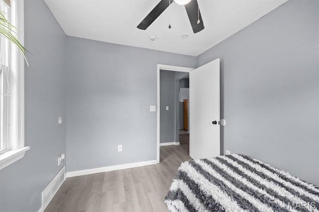 203 N Williams St, Albers, IL 62215 - unfurnished bedroom with wood finished floors, baseboards, and ceiling fan