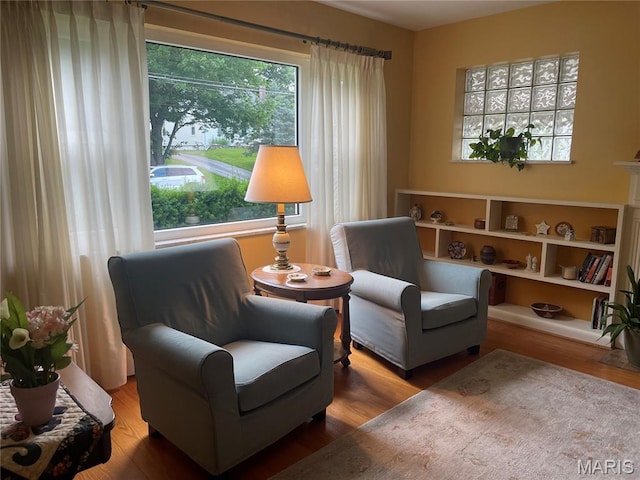 1034 Chelsea Ave, Glendale, MO 63122 - sitting room with plenty of natural light and wood finished floors
