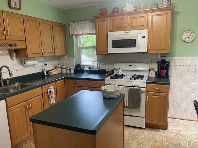 1034 Chelsea Ave, Glendale, MO 63122 - kitchen with white appliances, dark countertops, a kitchen island, and brown cabinets