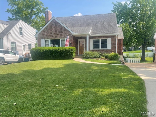1034 Chelsea Ave, Glendale, MO 63122 - view of front facade with a chimney, brick siding, a front yard, and roof with shingles