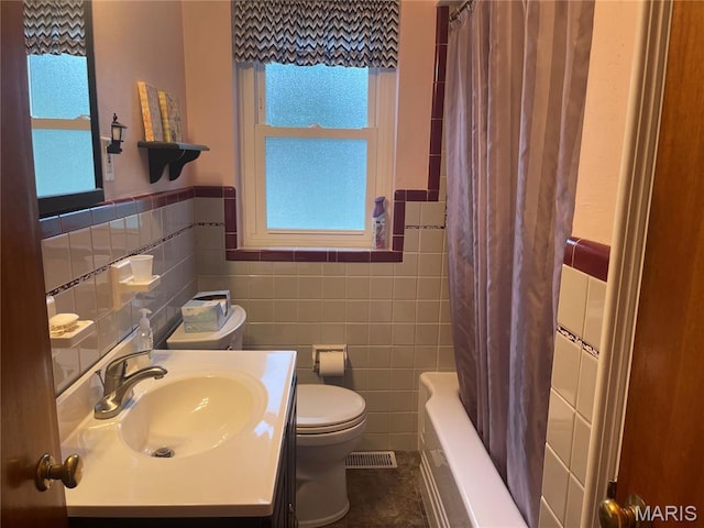 1034 Chelsea Ave, Glendale, MO 63122 - bathroom featuring tile walls, vanity, shower / bath combo, and a wainscoted wall
