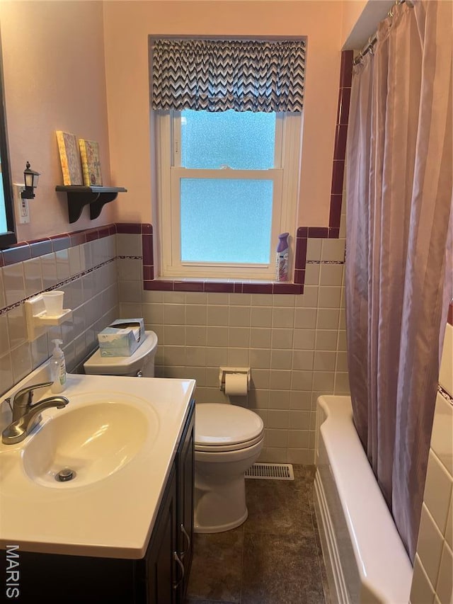 1034 Chelsea Ave, Glendale, MO 63122 - full bath with tile walls, vanity, a wainscoted wall, tile patterned floors, and shower / bath combination with curtain