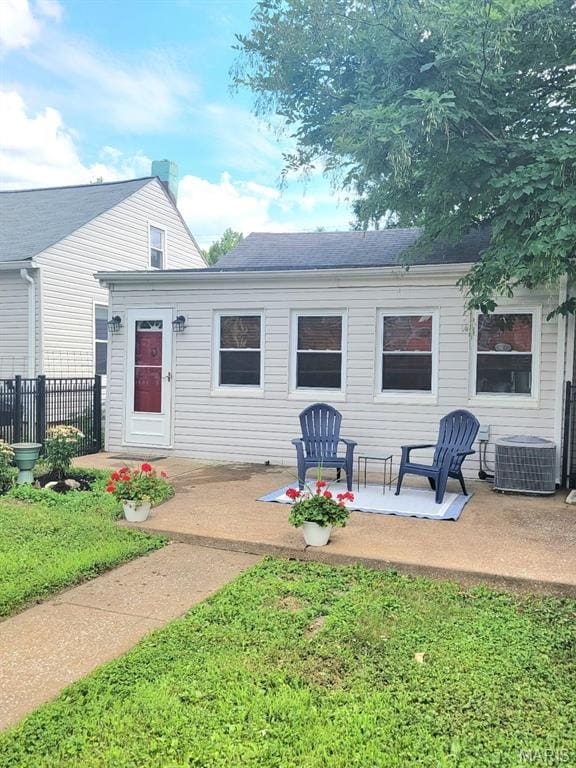 1928 Arsenal St, Saint Louis, MO 63118 - rear view of property featuring a patio area and a shingled roof