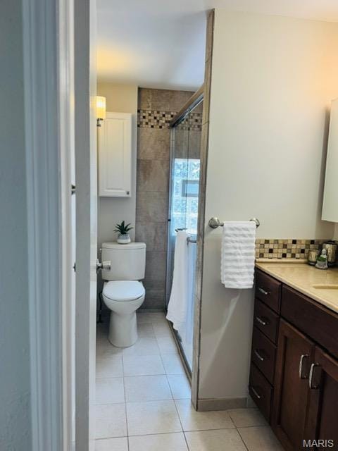 1928 Arsenal St, Saint Louis, MO 63118 - full bath featuring vanity, tile patterned floors, a stall shower, and decorative backsplash