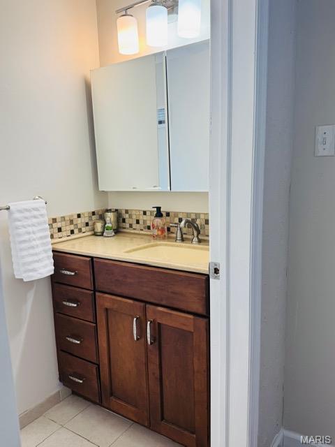 1928 Arsenal St, Saint Louis, MO 63118 - bathroom featuring vanity, tile patterned flooring, and decorative backsplash