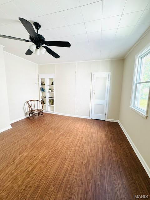1928 Arsenal St, Saint Louis, MO 63118 - spare room with wood finished floors, ornamental molding, a ceiling fan, and built in features