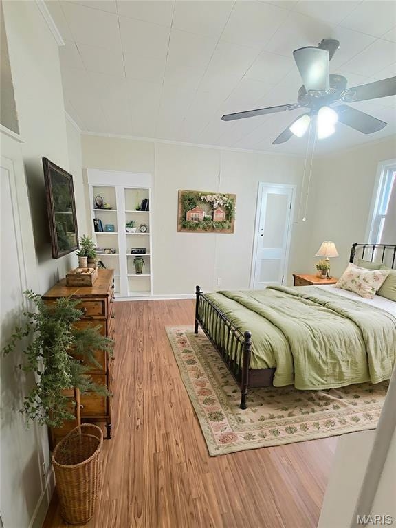 1928 Arsenal St, Saint Louis, MO 63118 - bedroom with light wood-type flooring, ceiling fan, and crown molding