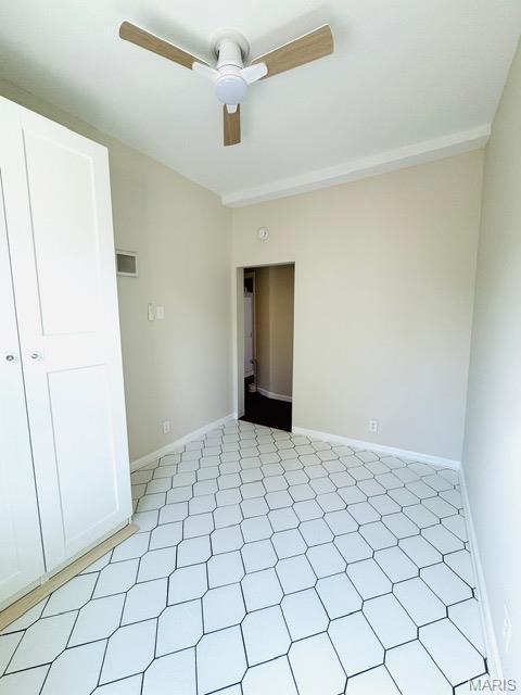 1928 Arsenal St, Saint Louis, MO 63118 - unfurnished bedroom featuring baseboards and a ceiling fan