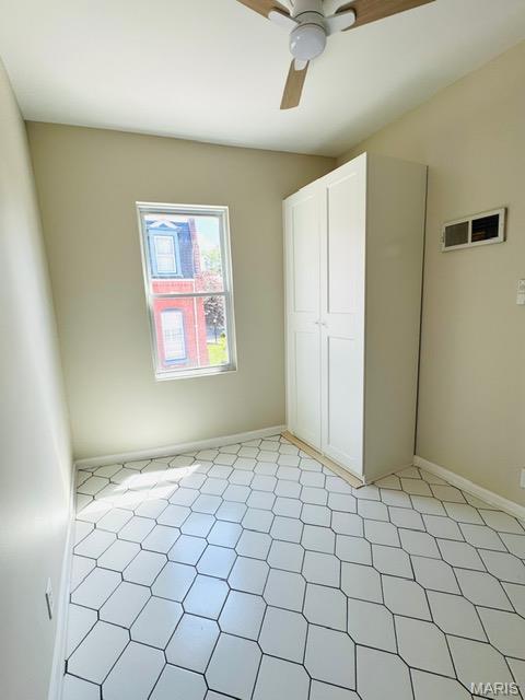 1928 Arsenal St, Saint Louis, MO 63118 - unfurnished bedroom with light flooring and a ceiling fan