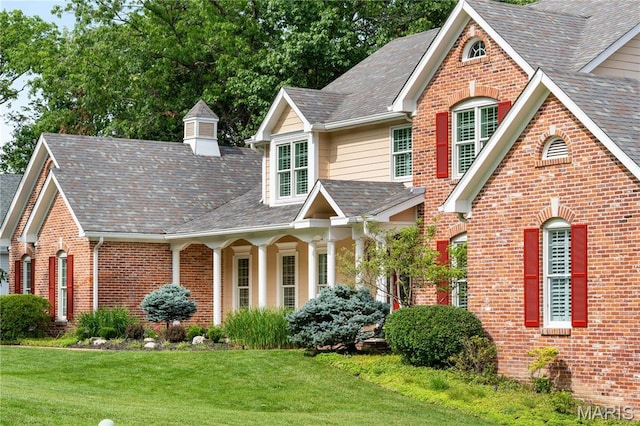 16427 Andraes Dr, Chesterfield, MO 63005 - traditional home featuring a front yard, brick siding, and a shingled roof