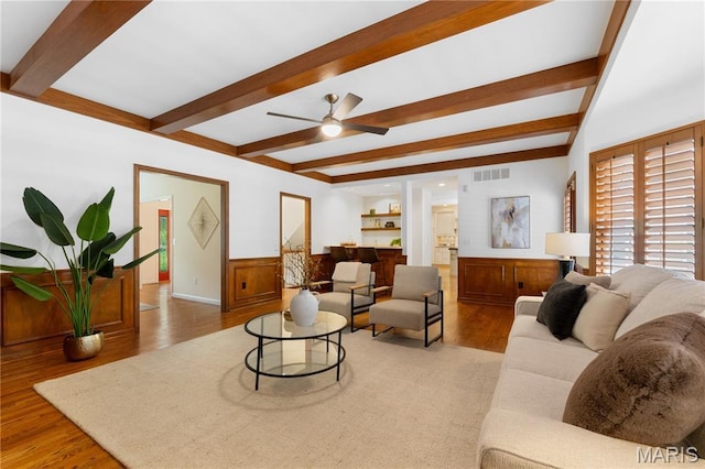 16427 Andraes Dr, Chesterfield, MO 63005 - living room featuring beam ceiling, wood finished floors, a ceiling fan, and wainscoting