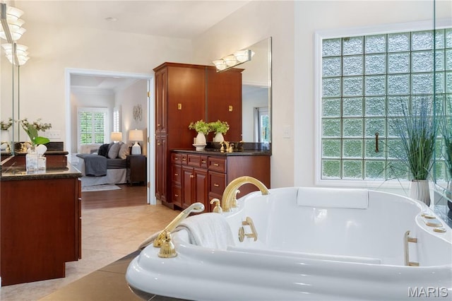 16427 Andraes Dr, Chesterfield, MO 63005 - bathroom featuring vanity, a garden tub, ornamental molding, connected bathroom, and tile patterned floors