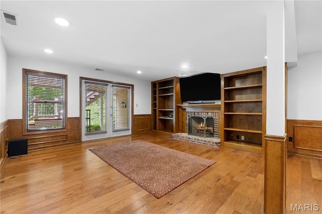16427 Andraes Dr, Chesterfield, MO 63005 - living area with wainscoting, a brick fireplace, recessed lighting, wood finished floors, and wood walls