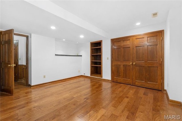 16427 Andraes Dr, Chesterfield, MO 63005 - empty room featuring built in features, recessed lighting, and light wood-type flooring