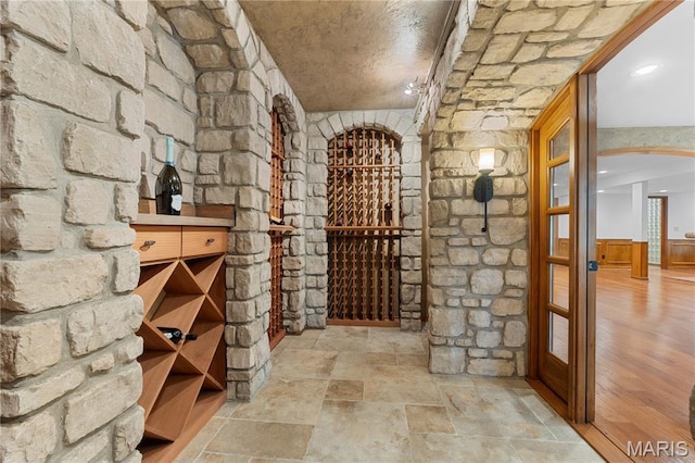 16427 Andraes Dr, Chesterfield, MO 63005 - wine area featuring arched walkways and stone finish flooring