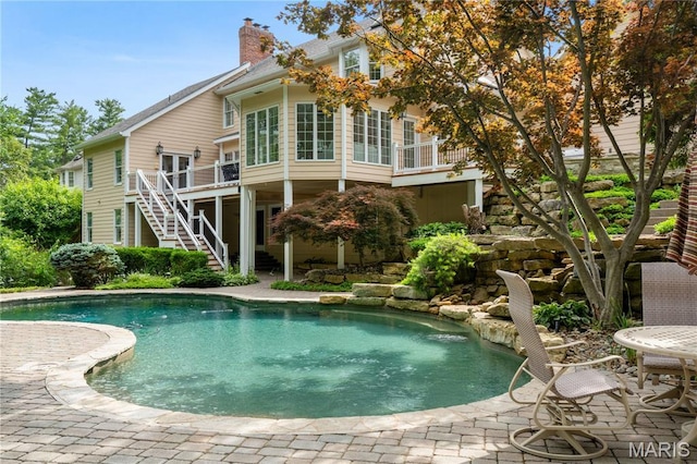 16427 Andraes Dr, Chesterfield, MO 63005 - swimming pool with stairs, a wooden deck, and a patio area