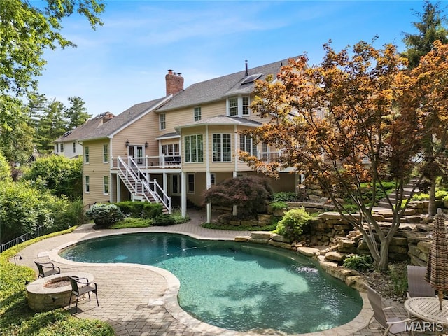 16427 Andraes Dr, Chesterfield, MO 63005 - outdoor pool featuring stairs, a deck, a fire pit, and a patio area