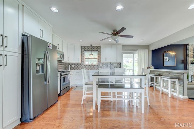713 Settler Rd, Fenton, MO 63026 - kitchen featuring appliances with stainless steel finishes, a ceiling fan, white cabinetry, backsplash, and recessed lighting