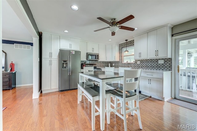 713 Settler Rd, Fenton, MO 63026 - kitchen with stainless steel appliances, ceiling fan, tasteful backsplash, healthy amount of natural light, and recessed lighting