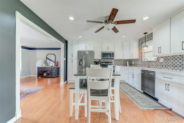 713 Settler Rd, Fenton, MO 63026 - kitchen featuring appliances with stainless steel finishes, ceiling fan, white cabinetry, tasteful backsplash, and recessed lighting