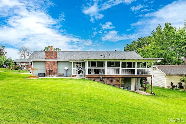 713 Settler Rd, Fenton, MO 63026 - rear view of property with a sunroom, a patio, a lawn, and a chimney