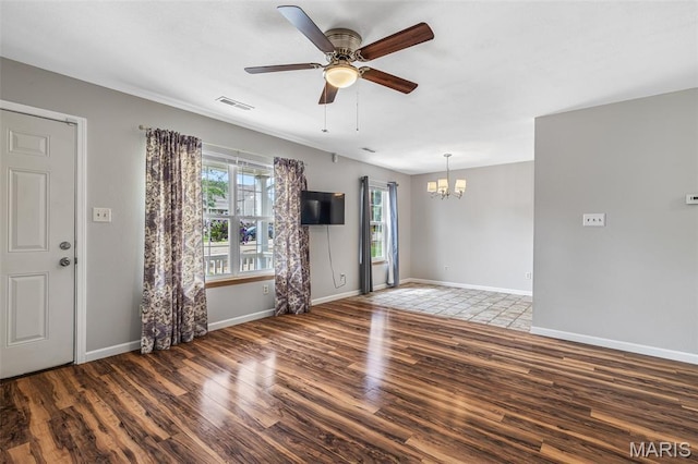310 S Harry Junior St, Desloge, MO 63601 - unfurnished living room with wood finished floors, a chandelier, a ceiling fan, and baseboards