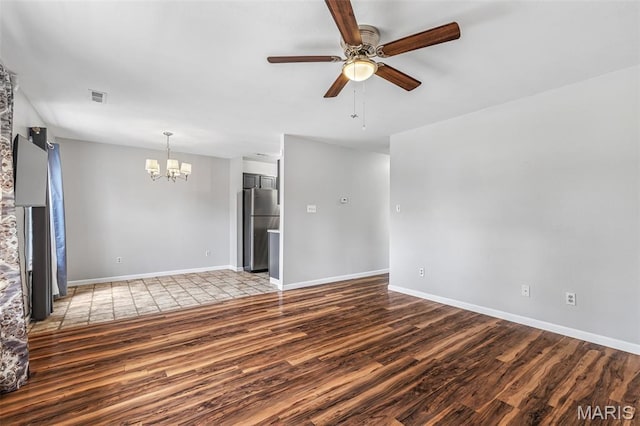 310 S Harry Junior St, Desloge, MO 63601 - unfurnished living room featuring wood finished floors, a chandelier, ceiling fan, and baseboards