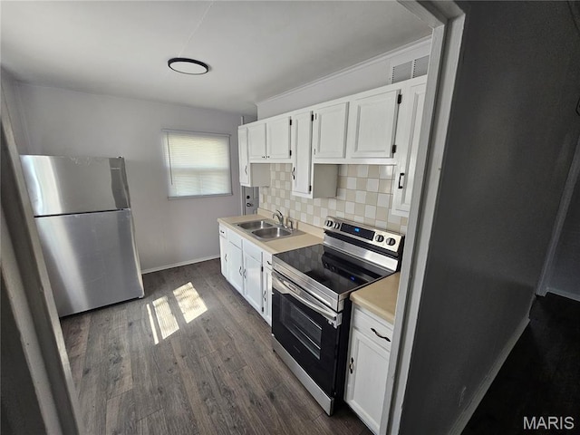 1150 Lilac Dr, Belleville, IL 62220 - kitchen with appliances with stainless steel finishes, a sink, white cabinets, dark wood-style flooring, and light countertops