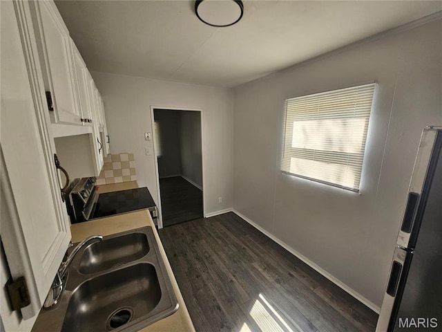 1150 Lilac Dr, Belleville, IL 62220 - kitchen featuring stainless steel electric stove, fridge with ice dispenser, a sink, white cabinetry, and dark wood-style floors