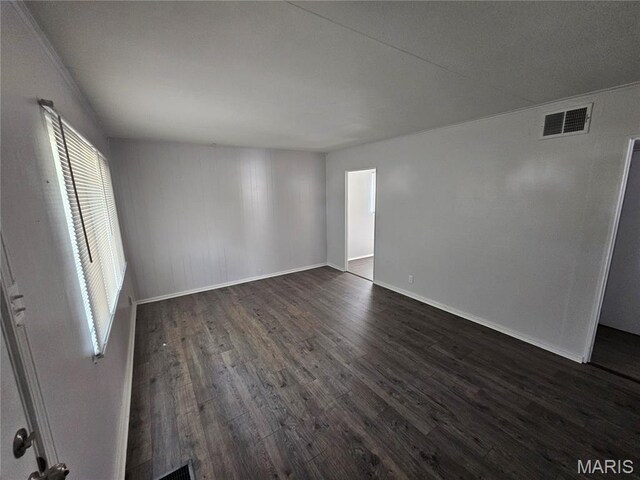 1150 Lilac Dr, Belleville, IL 62220 - spare room featuring dark wood-type flooring and baseboards