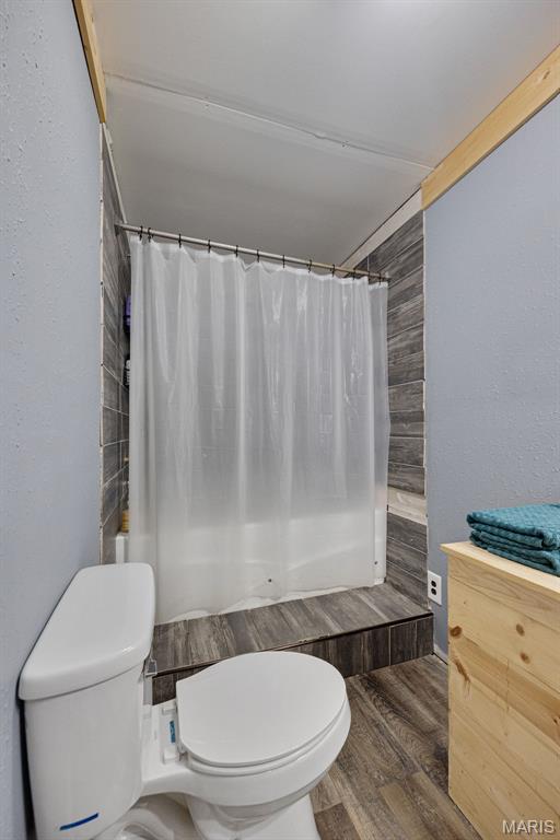 14864 S State Highway 21, Potosi, MO 63664 - full bathroom with toilet, wood finished floors, and shower / bathtub combination with curtain