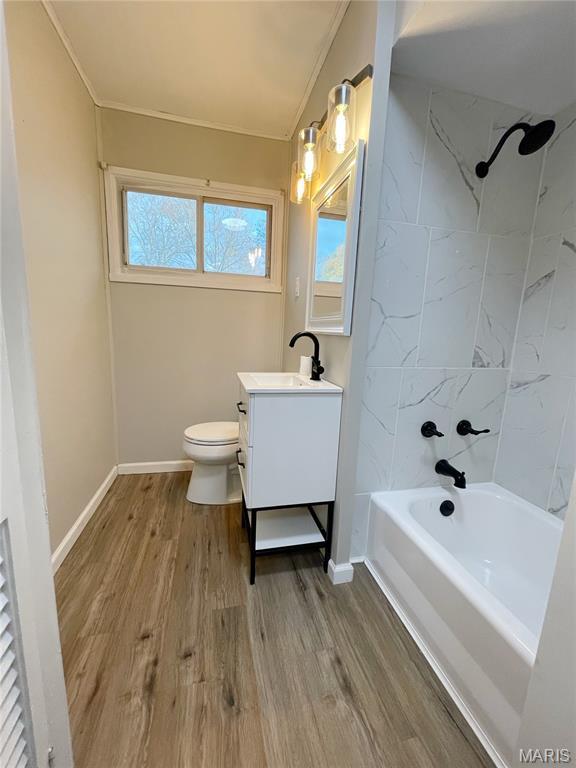 913 N 38th St, Belleville, IL 62226 - full bathroom featuring vanity, wood finished floors, ornamental molding, washtub / shower combination, and toilet