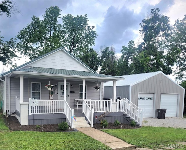 512 W Olive St, Palmyra, MO 63461 - view of front facade with covered porch, a garage, a front yard, and metal roof
