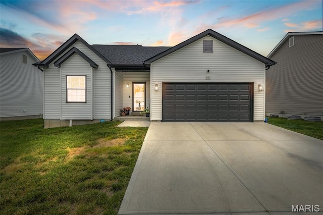 view of front of property with a front yard, a garage, and concrete driveway