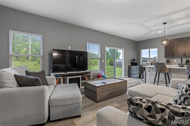 living room with light wood-type flooring and recessed lighting