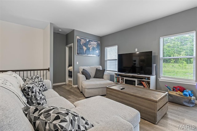 living room with light wood-style flooring and plenty of natural light