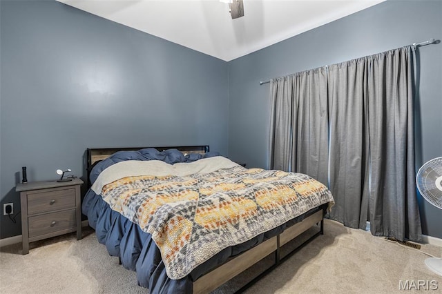 bedroom with light carpet, a ceiling fan, and baseboards