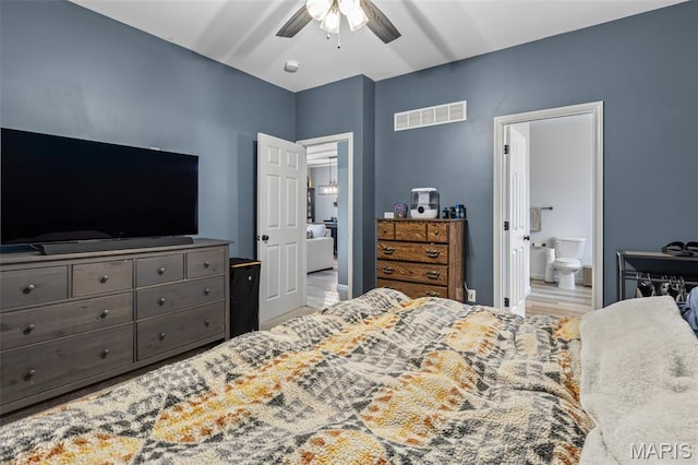 bedroom with connected bathroom, a ceiling fan, and wood finished floors