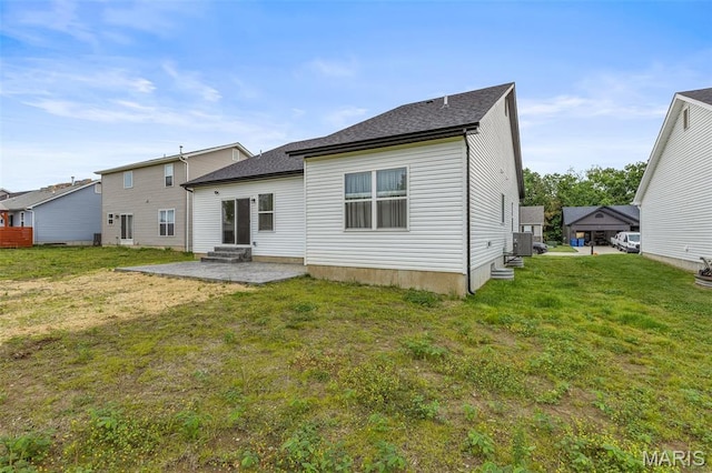 back of house with a patio, entry steps, a lawn, cooling unit, and a shingled roof