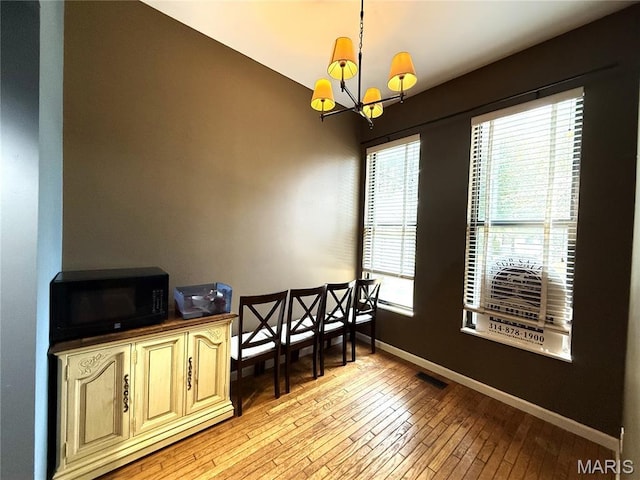 4333 Laclede Ave Unit D, Saint Louis, MO 63108 - dining area featuring light wood-type flooring, a chandelier, and baseboards