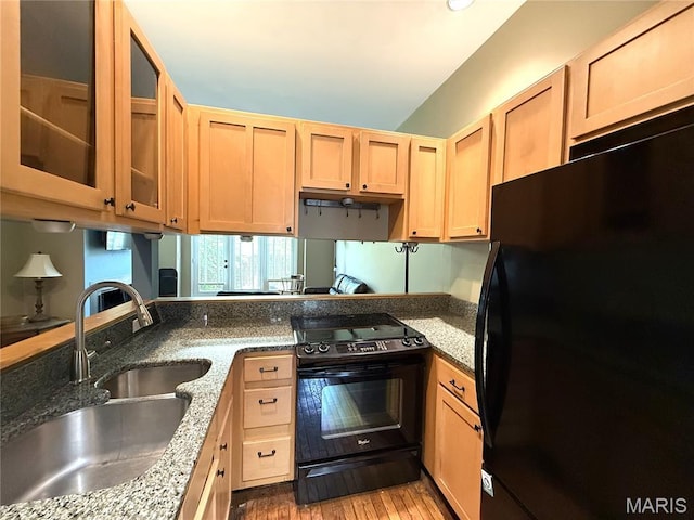 4333 Laclede Ave Unit D, Saint Louis, MO 63108 - kitchen with fridge, black range with electric stovetop, a sink, light brown cabinetry, and glass insert cabinets