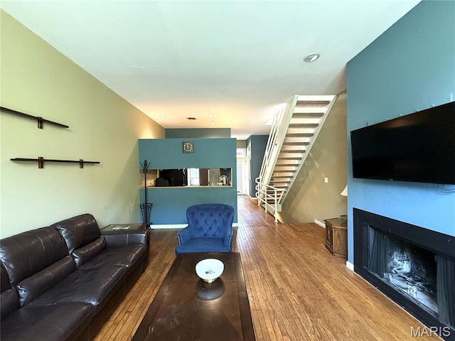 4333 Laclede Ave Unit D, Saint Louis, MO 63108 - living area featuring stairs, wood finished floors, and a fireplace