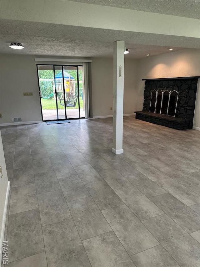 305 Berkshire Dr, Belleville, IL 62223 - unfurnished living room featuring a textured ceiling and a fireplace